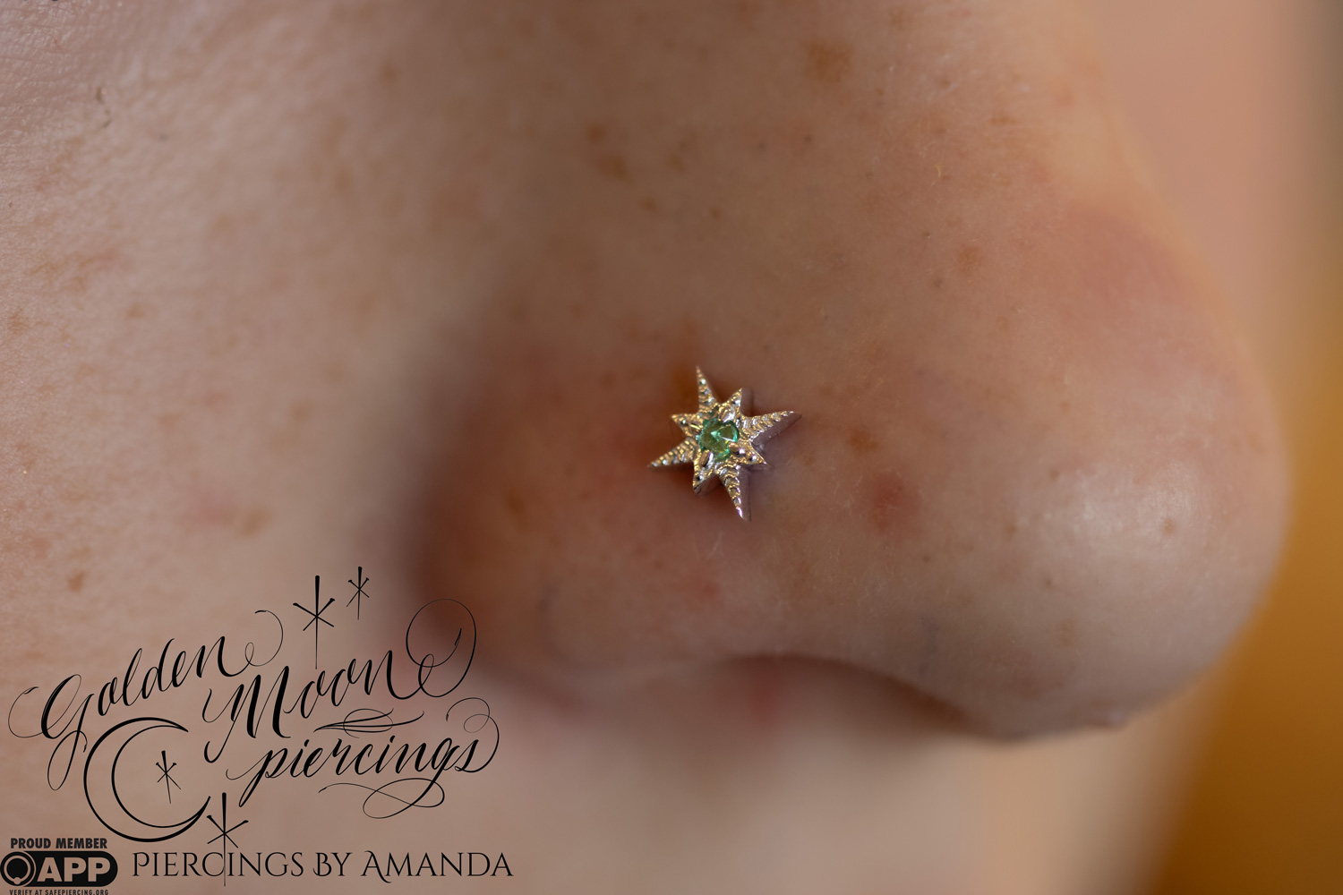 Fresh nostril piercing with 14k white gold and genuine emerald